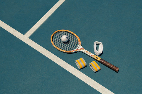 Close-up of classic tennis ball and wood racket – nostalgic sports photo