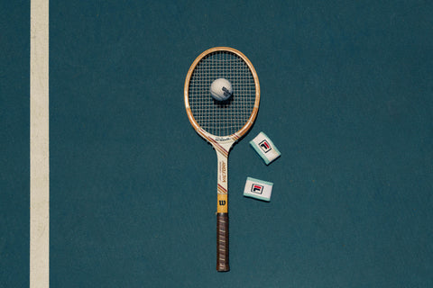 Close-up of classic tennis ball and wood racket – nostalgic sports photo